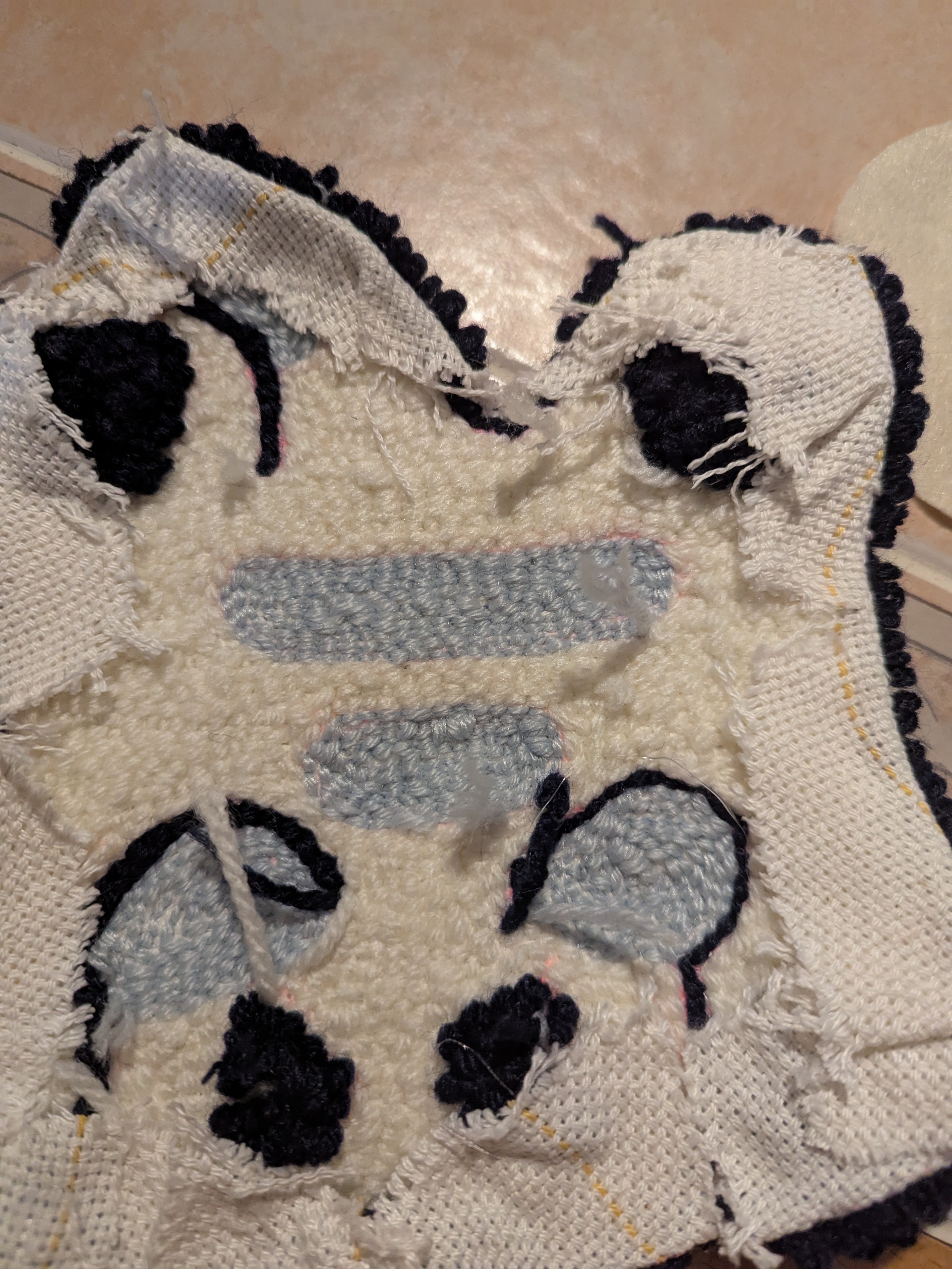 The back stitching of a cat rug